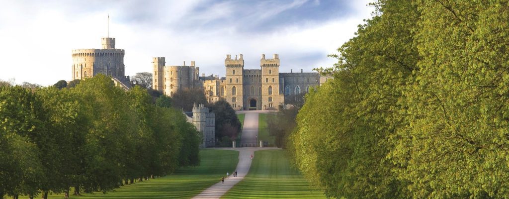 Beautiful image of Windosr Castle from the long walk surrounded by trees and landscaped neat lawns
