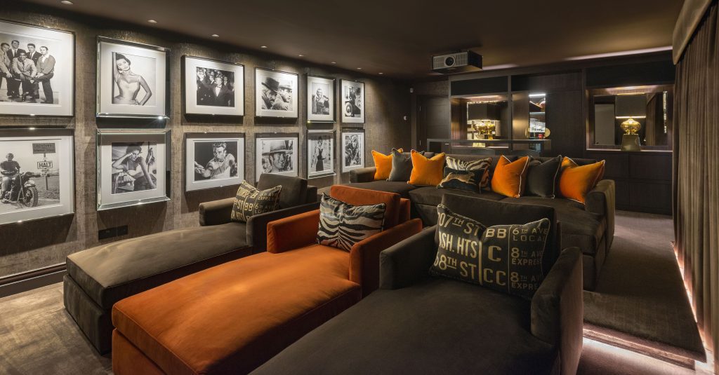 Luxury cinema room with Wolfe inspired Luxe home cinema Cobham Surrey in soft brown designer fabrics and Andrew Martin cushions