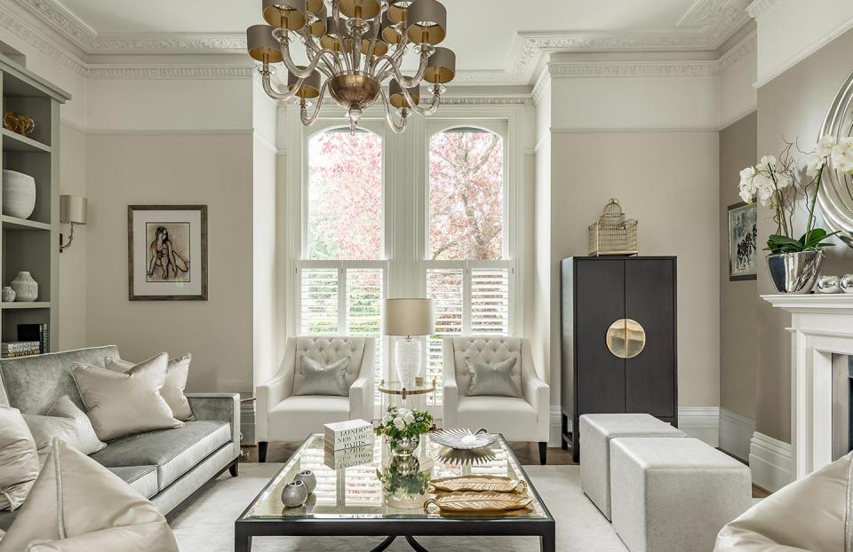 Rich and elegant cream living room interior with chandelier and stunning architectural detailing